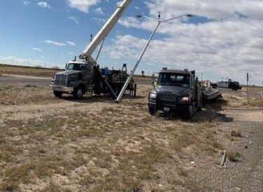 erecting light poles at SH 302 widening and improvements project